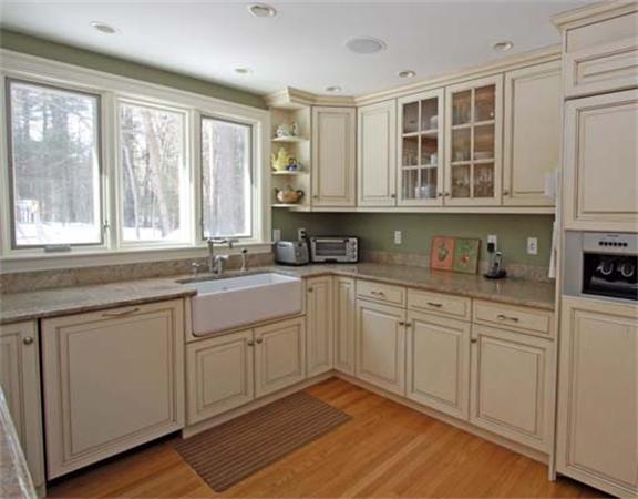 35 Pinecroft Road Weston, MA 02493 - Photo 6 of 17 a kitchen with granite countertop white cabinets stainless steel appliances a sink and a window
