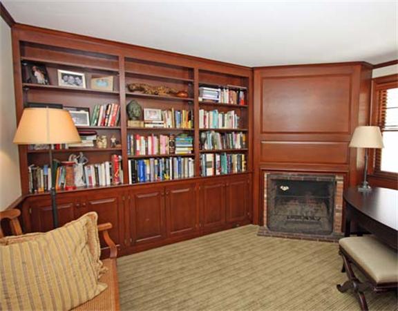 35 Pinecroft Road Weston, MA 02493 - Photo 9 of 17 a living room with bookshelf and a fireplace
