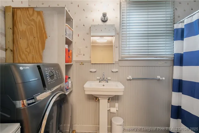 a bathroom with a sink a mirror and a toilet