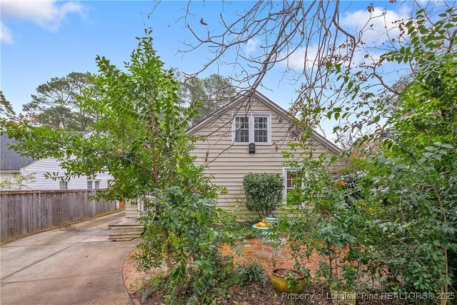 a house is sitting in middle of forest