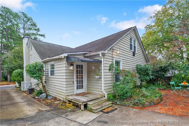 a backyard of a house with plants and trees