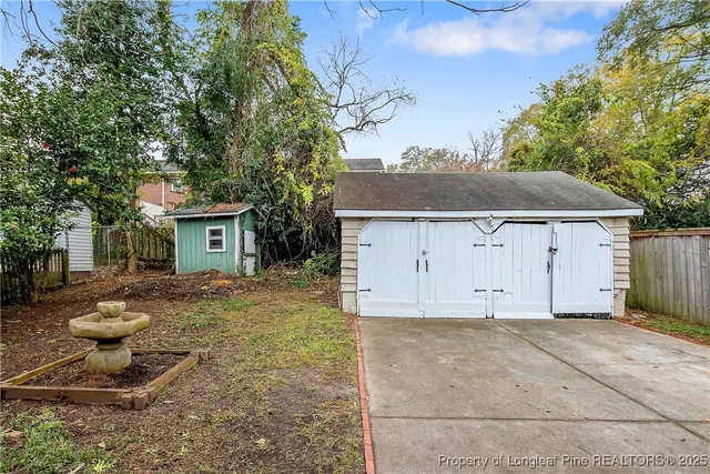 a view of a small house with backyard