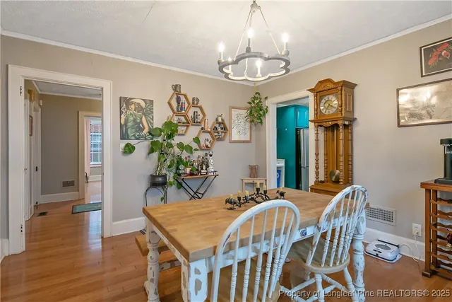 a view of a dining room with furniture wooden floor and chandelier