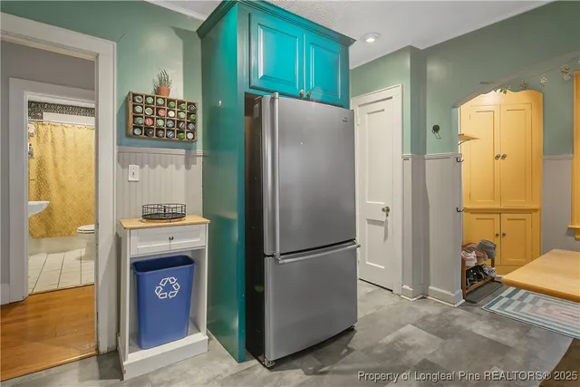 a kitchen with stainless steel appliances granite countertop a refrigerator and a stove