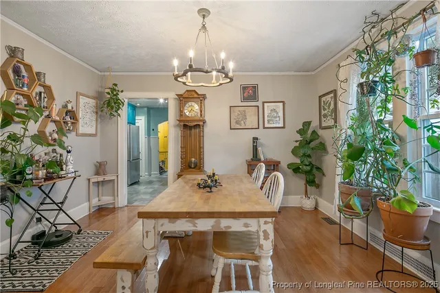 a view of a dining room with furniture and chandelier