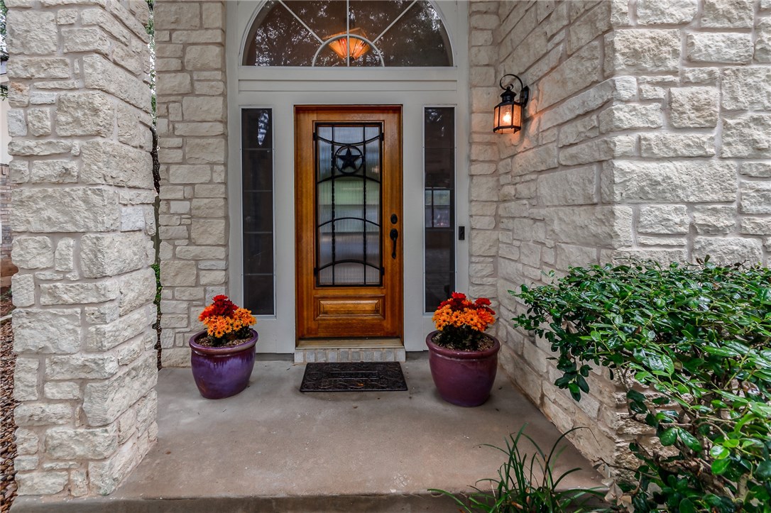 a view of a door of the house with outdoor seating