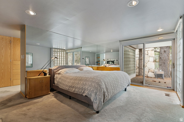 1856 Fort Canyon Road Alpine, UT 84004 - Photo 34 of 49 Carpeted room featuring a large sliding glass door, recessed lighting, mirrored wall panels, and built-in wood-finish cabinetry