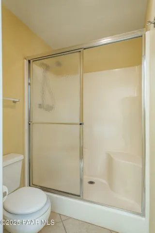 a bathroom with a shower and a toilet