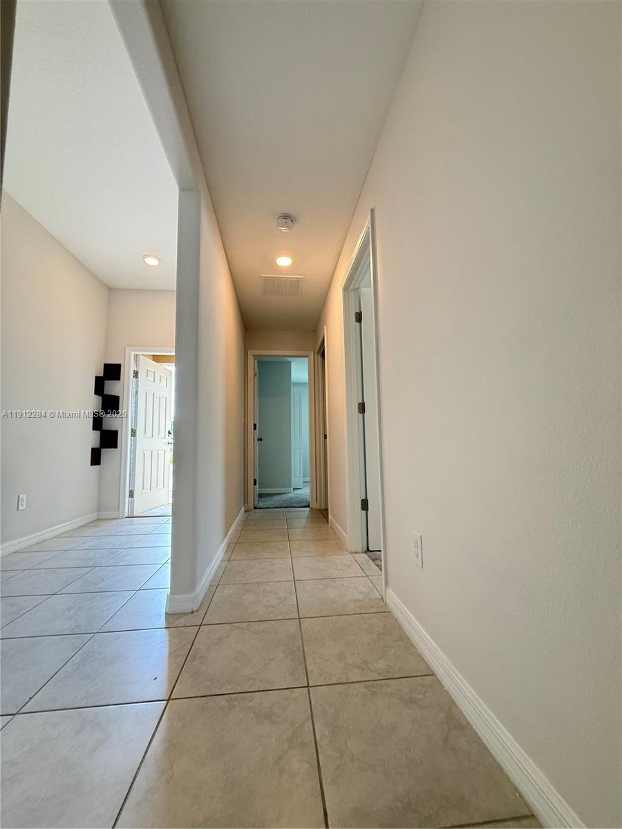 39889 Harmon Grove Court Zephyrhills, FL 33540 - Photo 14 of 55 a view of a hallway with wooden shelves