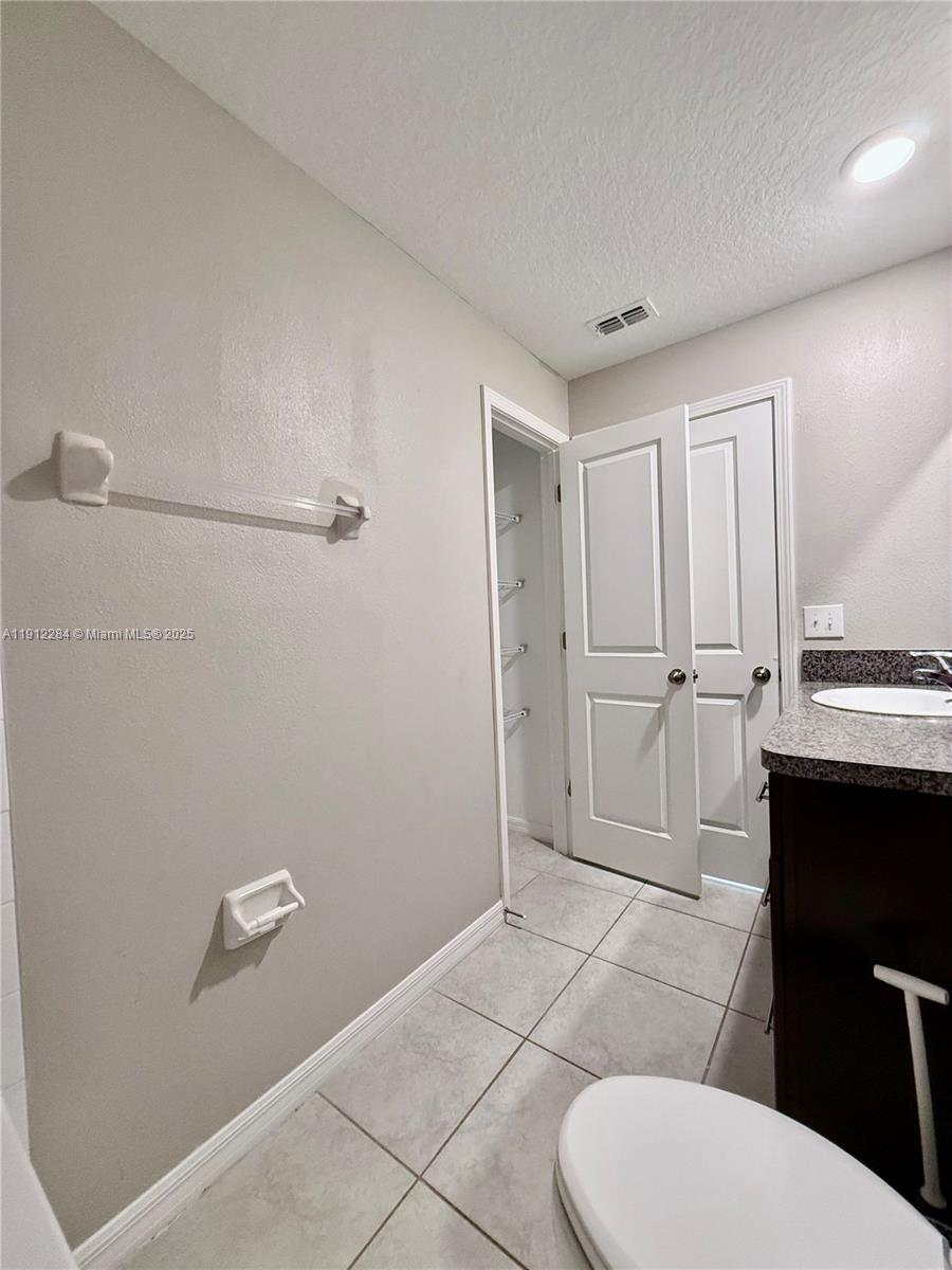 39889 Harmon Grove Court Zephyrhills, FL 33540 - Photo 21 of 55 a bathroom with a granite countertop toilet and a sink