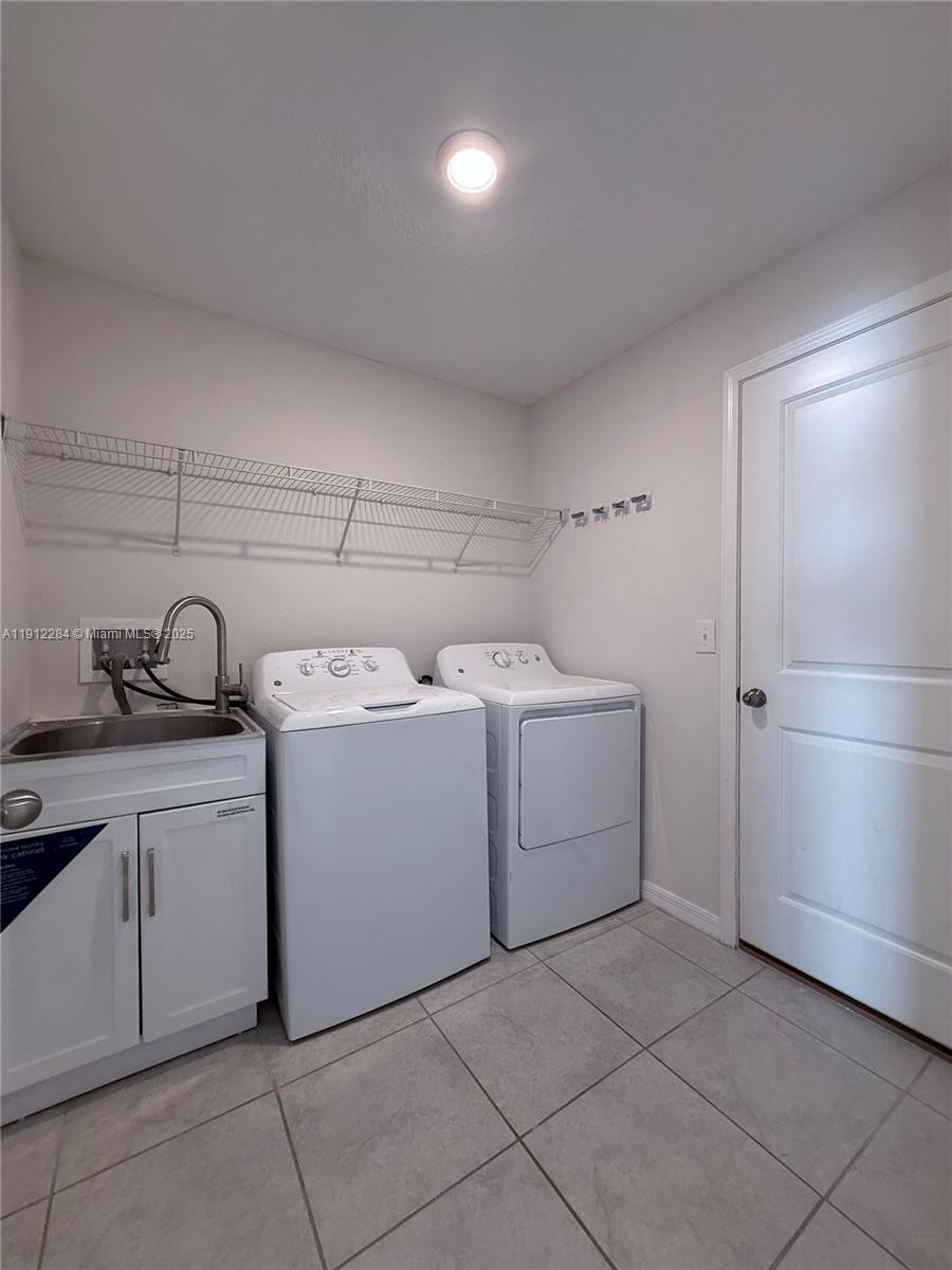 39889 Harmon Grove Court Zephyrhills, FL 33540 - Photo 30 of 55 a utility room with cabinets washer and dryer