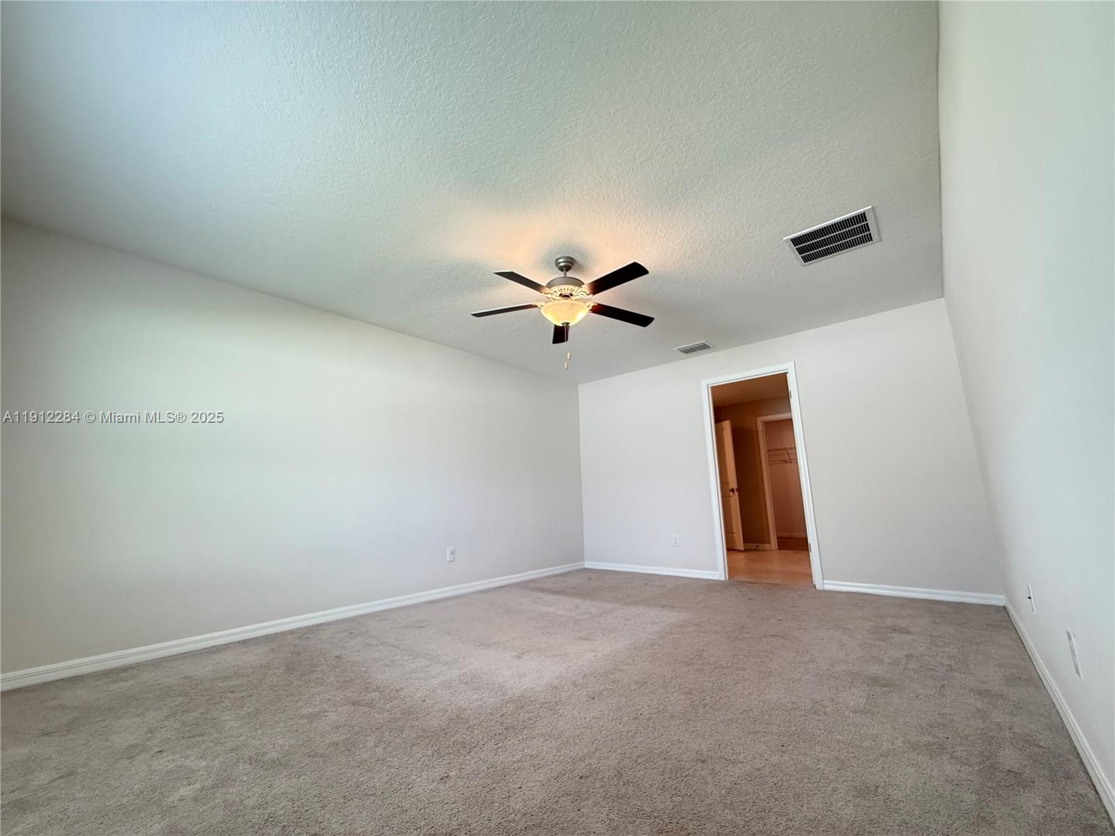 39889 Harmon Grove Court Zephyrhills, FL 33540 - Photo 34 of 55 an empty room with closet and a ceiling fan
