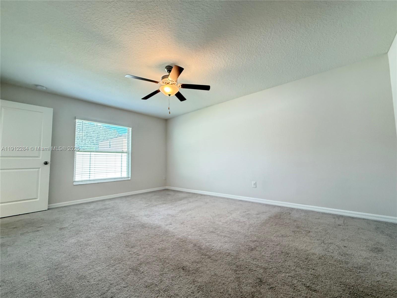 39889 Harmon Grove Court Zephyrhills, FL 33540 - Photo 35 of 55 an empty room with a window and a ceiling fan