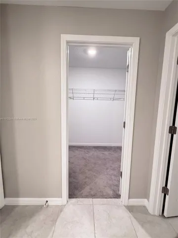 a view of a bathroom with a sink and a mirror