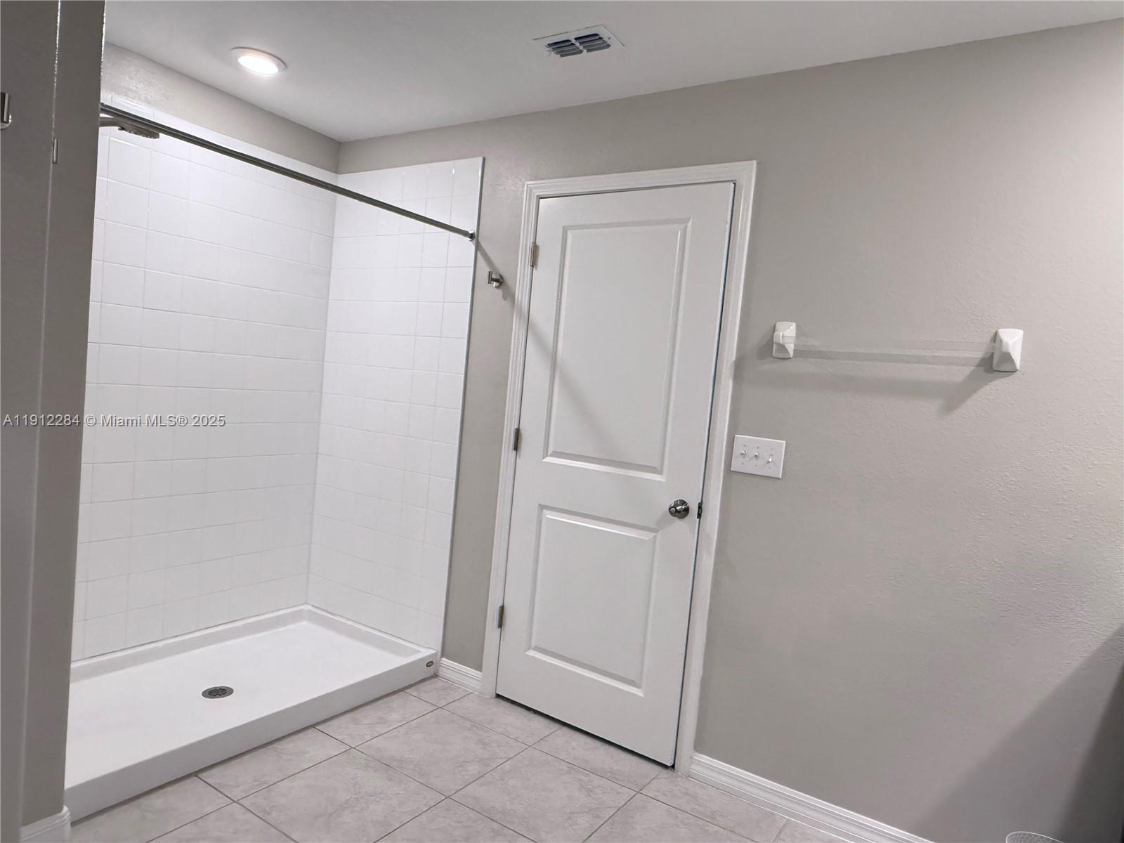 39889 Harmon Grove Court Zephyrhills, FL 33540 - Photo 46 of 55 a bathroom with a glass shower door