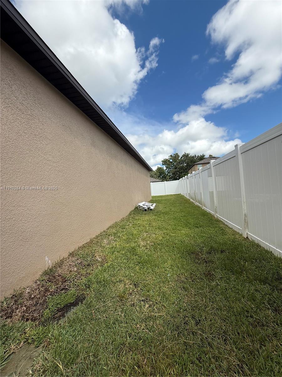 39889 Harmon Grove Court Zephyrhills, FL 33540 - Photo 53 of 55 a backyard of a house with lots of green space