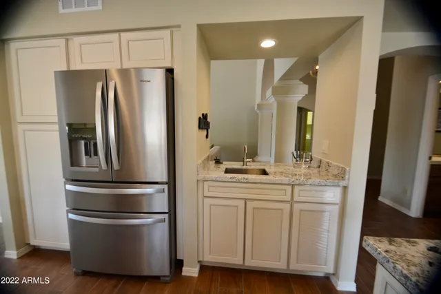 a kitchen with stainless steel appliances a refrigerator and a sink