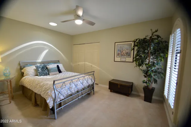 a bedroom with a bed and a potted plant