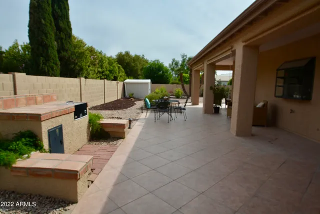 a view of a patio with table and chairs potted plants with wooden floor