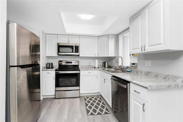 a kitchen with a sink stove and refrigerator