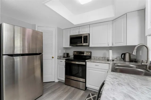 a kitchen with a refrigerator stove and sink