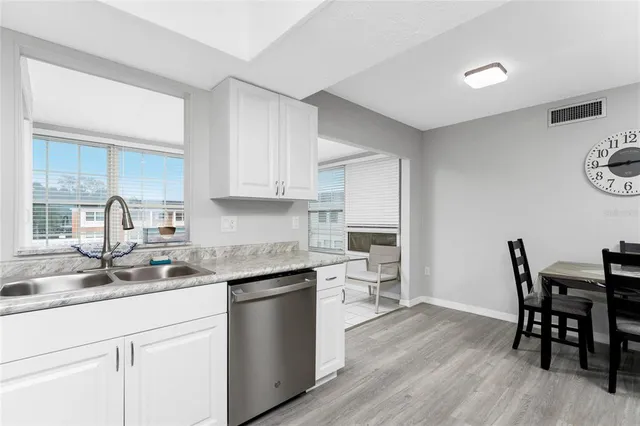 a kitchen with a table and chairs in it