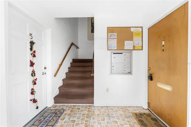 a view of an entryway with wooden floor