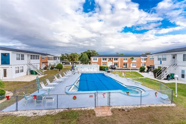 a view of a swimming pool with an outdoor seating and a yard