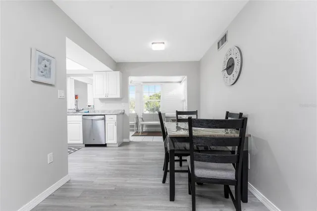a view of a dining room with furniture and a chandelier