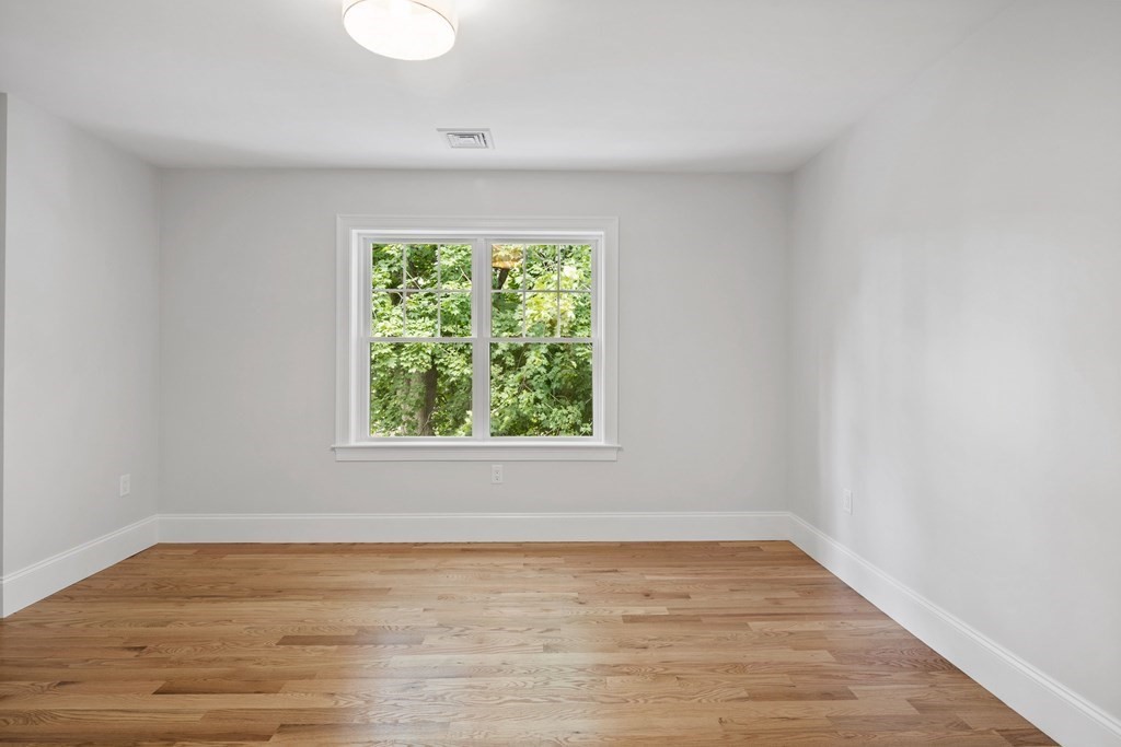 31 Kenilworth Road Arlington, MA 02476 - Photo 26 of 41 an empty room with wooden floor and windows