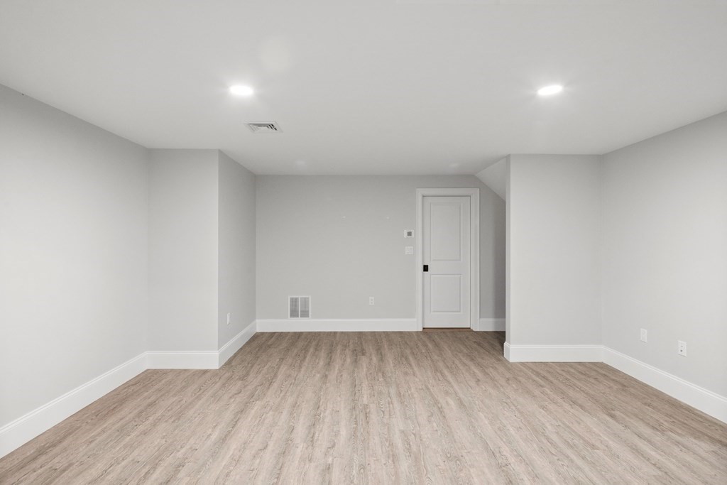 31 Kenilworth Road Arlington, MA 02476 - Photo 35 of 41 a view of room with wooden floor and white walls