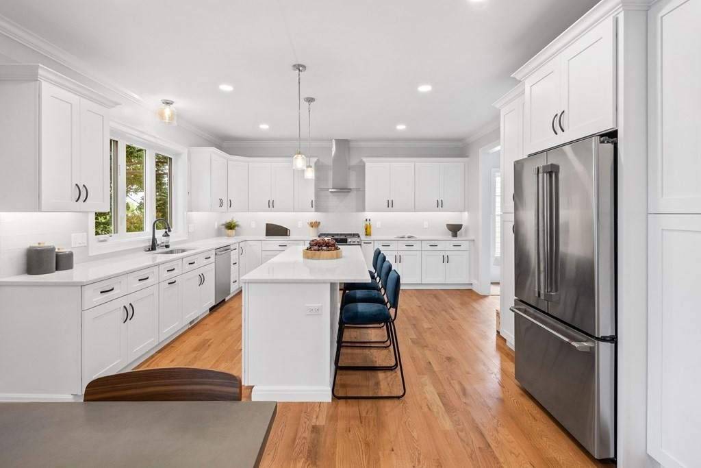 31 Kenilworth Road Arlington, MA 02476 - Photo 7 of 41 a kitchen with white cabinets and stainless steel appliances