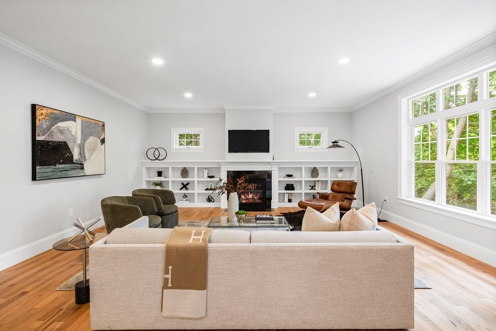 31 Kenilworth Road Arlington, MA 02476 - Photo 9 of 41 a living room with furniture a fireplace and a large window