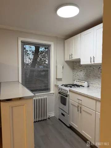 a kitchen with a stove a sink and a microwave
