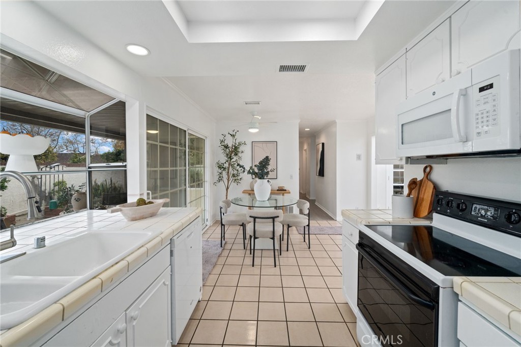 2181 Maple Court Tustin, CA 92780 - Photo 19 of 29 a kitchen with stainless steel appliances kitchen island granite countertop a sink and cabinets