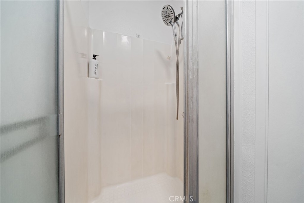2181 Maple Court Tustin, CA 92780 - Photo 29 of 29 a bathroom with a glass shower door