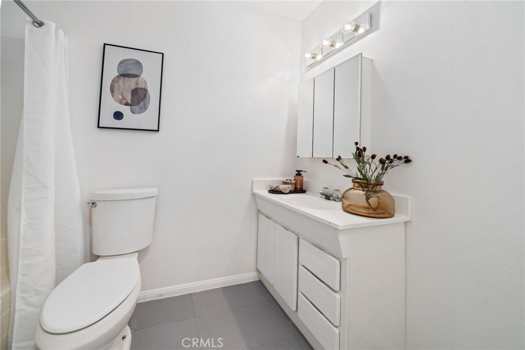 2181 Maple Court Tustin, CA 92780 - Photo 9 of 29 a bathroom with a toilet sink and mirror
