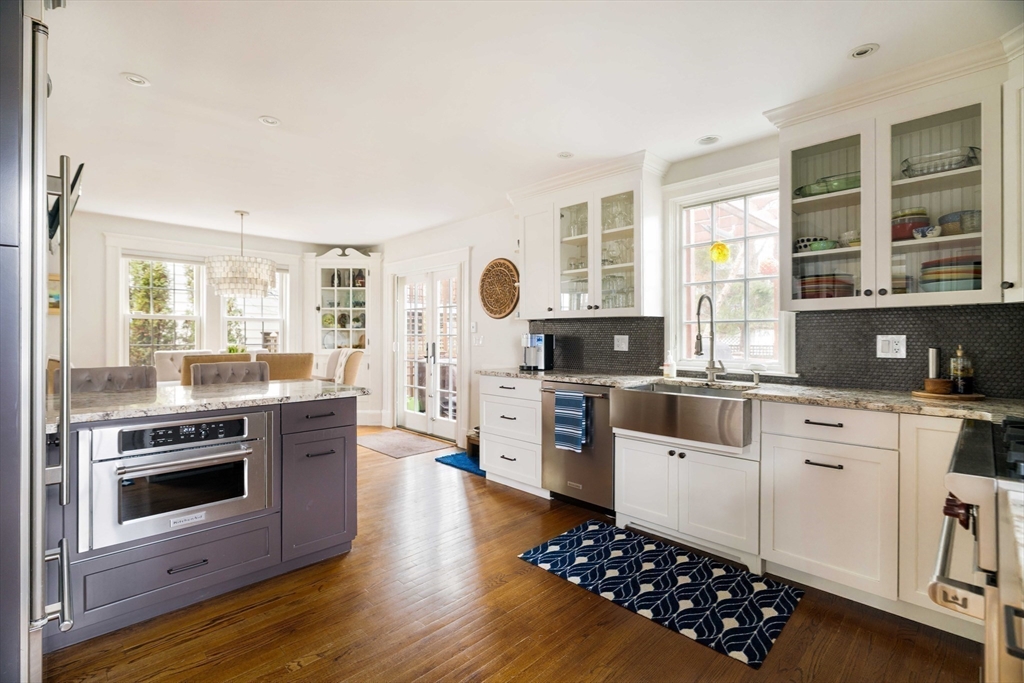 9 Eastern Avenue Arlington, MA 02476 - Photo 11 of 40 a kitchen with stainless steel appliances kitchen island granite countertop a stove a sink and a microwave