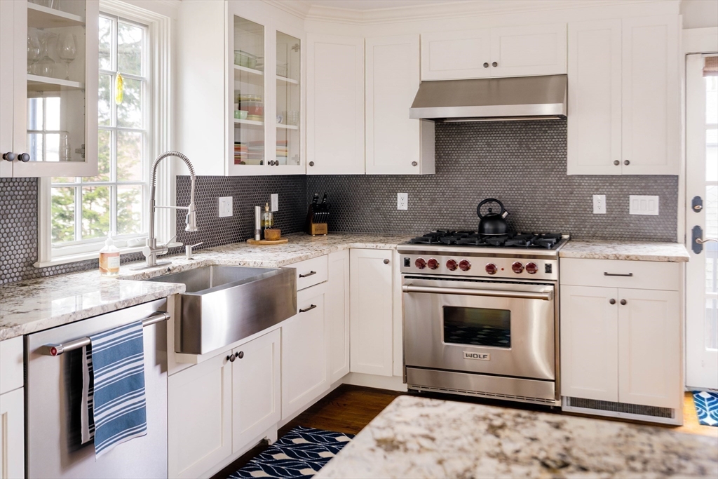 9 Eastern Avenue Arlington, MA 02476 - Photo 12 of 40 a kitchen with stainless steel appliances a stove a sink and a microwave