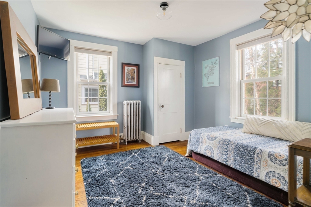 9 Eastern Avenue Arlington, MA 02476 - Photo 25 of 40 a bedroom with a bed and a large window with outer view