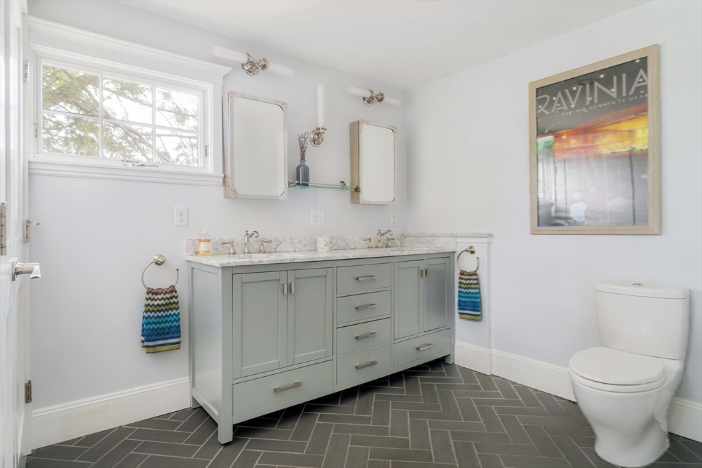 9 Eastern Avenue Arlington, MA 02476 - Photo 27 of 40 a spacious bathroom with a granite countertop sink toilet and a window