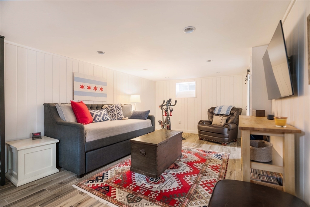 9 Eastern Avenue Arlington, MA 02476 - Photo 32 of 40 a living room with furniture a flat screen tv and a fireplace