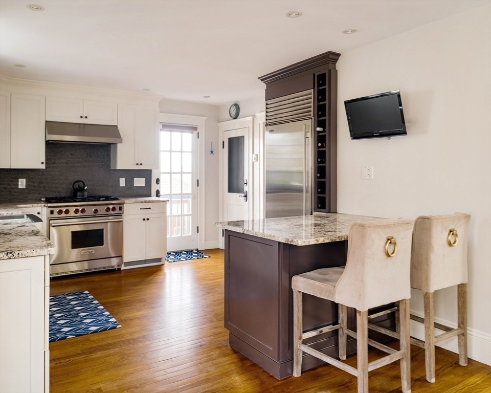 9 Eastern Avenue Arlington, MA 02476 - Photo 9 of 40 a kitchen with stainless steel appliances kitchen island granite countertop a stove a sink and a refrigerator