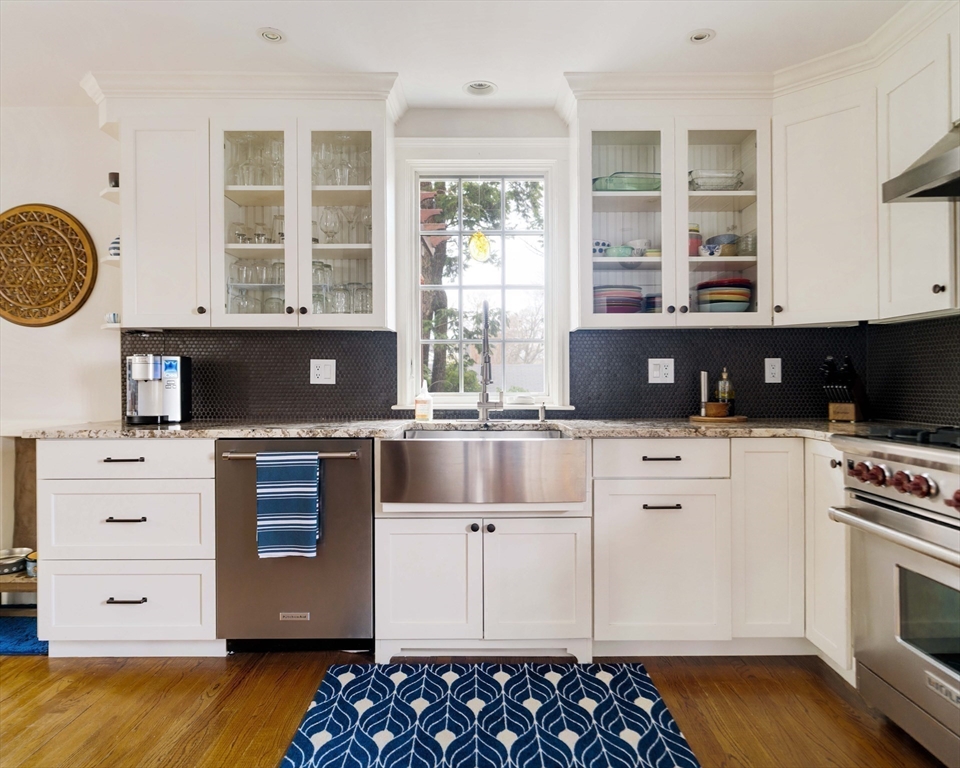 9 Eastern Avenue Arlington, MA 02476 - Photo 10 of 40 a kitchen with kitchen island granite countertop a sink and a stove