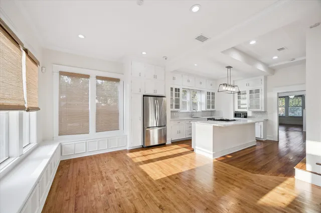 a large kitchen with stainless steel appliances refrigerator sink and cabinets