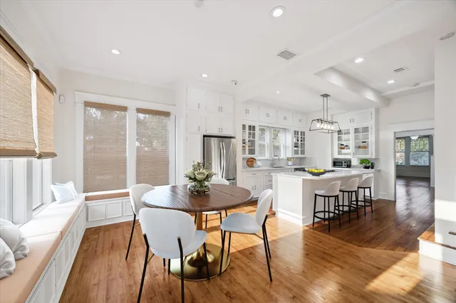 a dining room with furniture and wooden floor