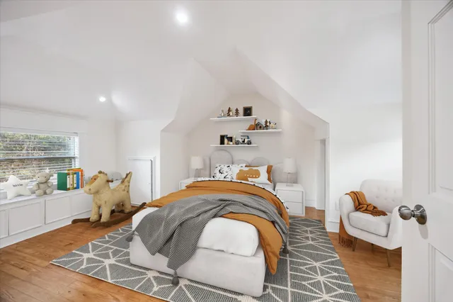 a bedroom with furniture and a wooden floor