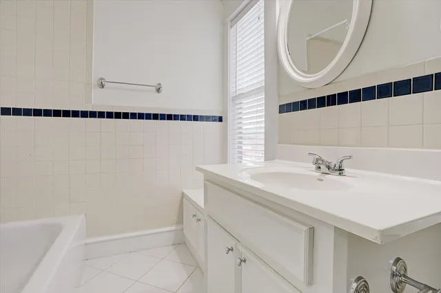 a bathroom with a sink a mirror and a shower