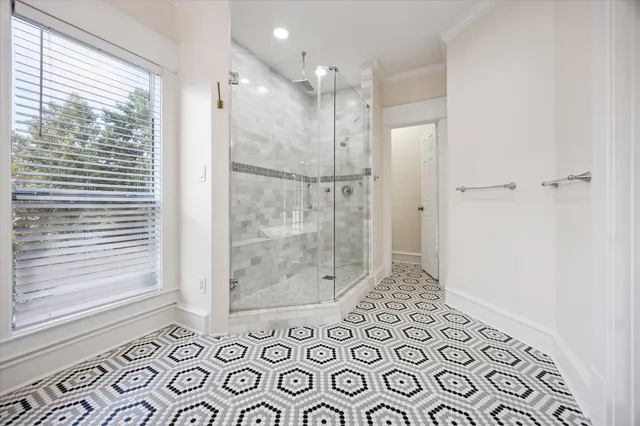 a bathroom with a glass shower door