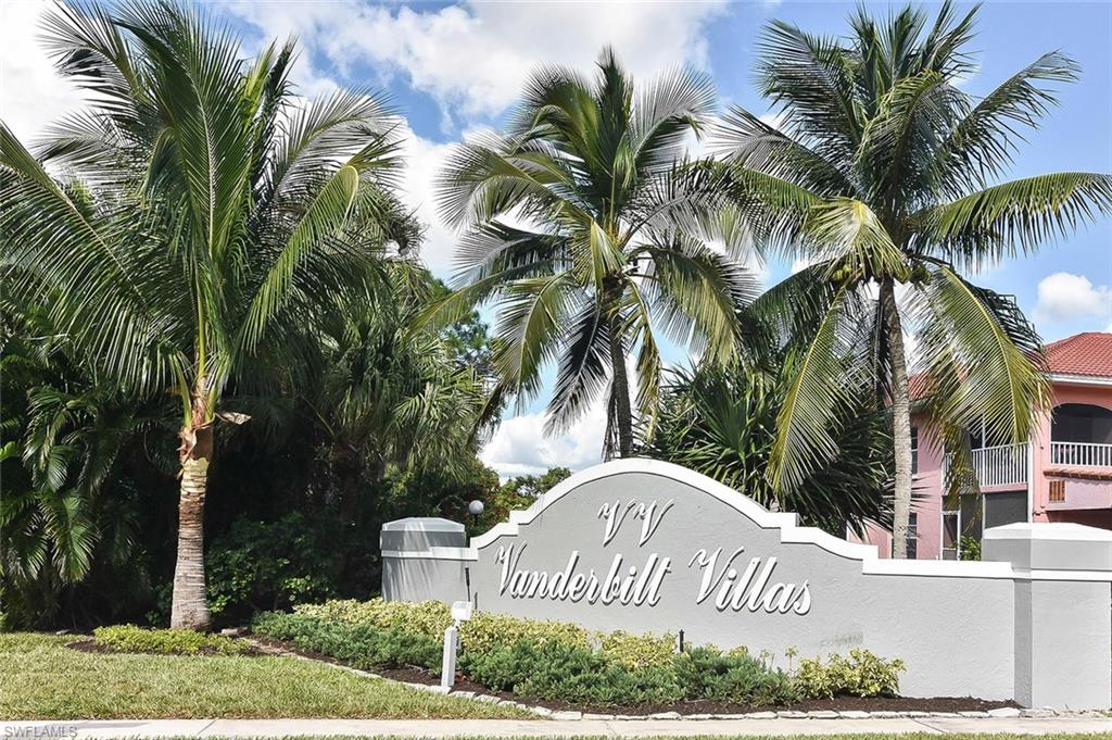 519 Roma Court, Unit 3208 Naples, FL 34110 - Photo 1 of 22 a sign that is sitting in front of a house with a yard and trees